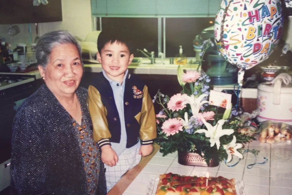 First-general medical student Danny Đoàn, pictured as a young child with his grandmother. 