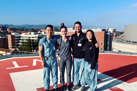 Four medical residents standing ontop a helipad at ucla