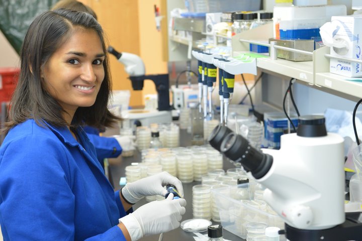 A research trainee smiles at the bench.